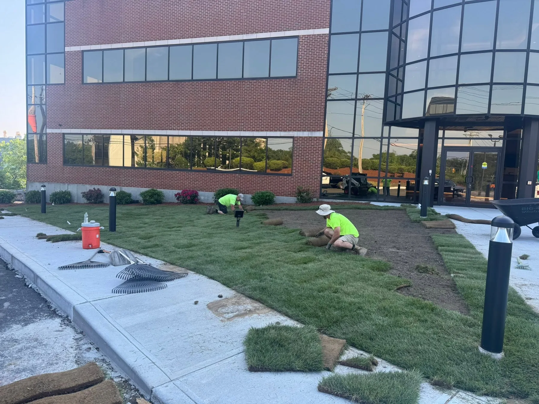 Adams Landscapes crew installing turf at a large commercial office building